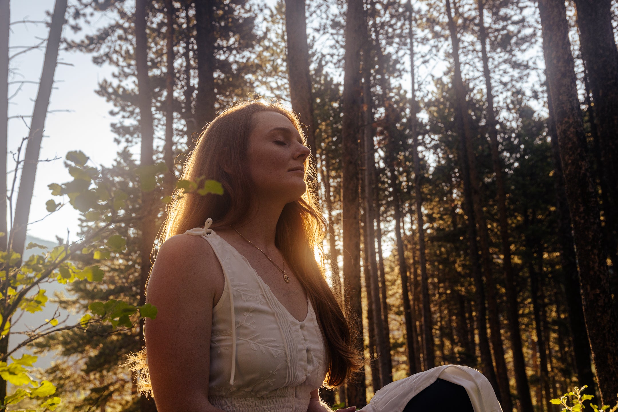 Inner Goddess on spiritual journey meditating in forest discovering talisman symbol jewelry in serenity