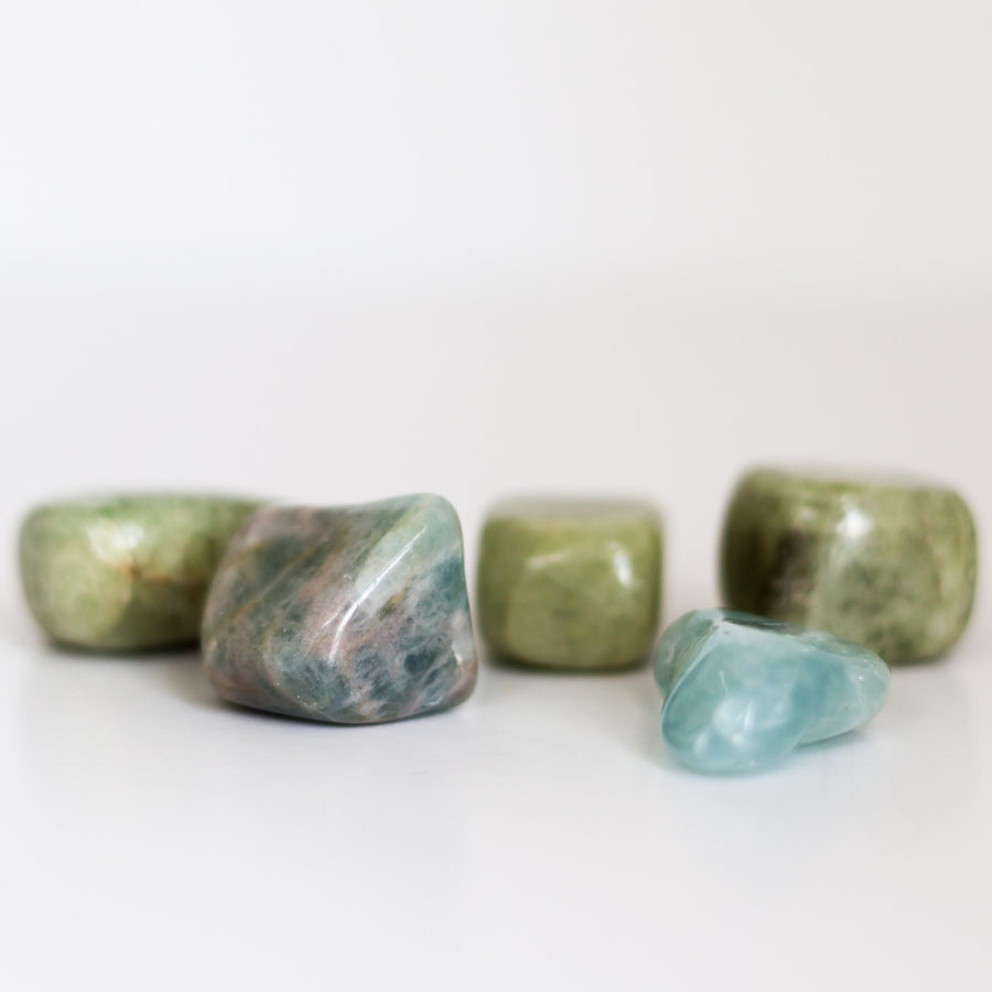 A collection of polished Aquamarine tumblestones on a light background.