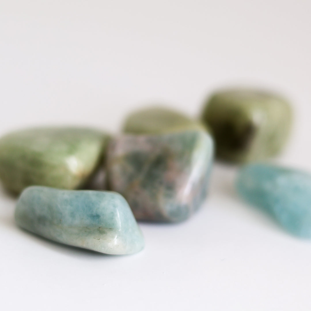 A collection of polished Aquamarine tumblestones on a light background.