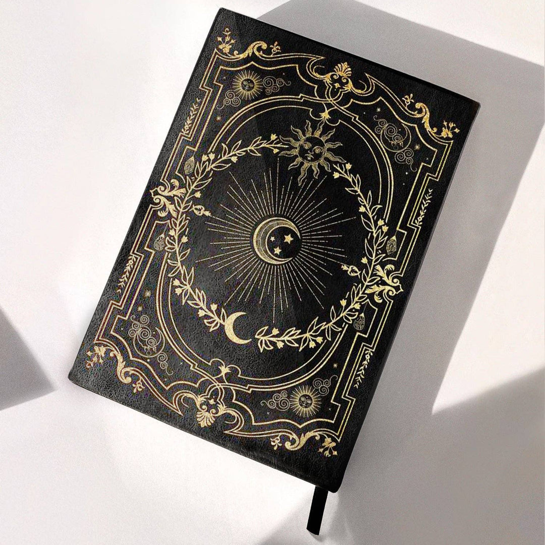 Black Dream ritual journal with gilded design on a white background