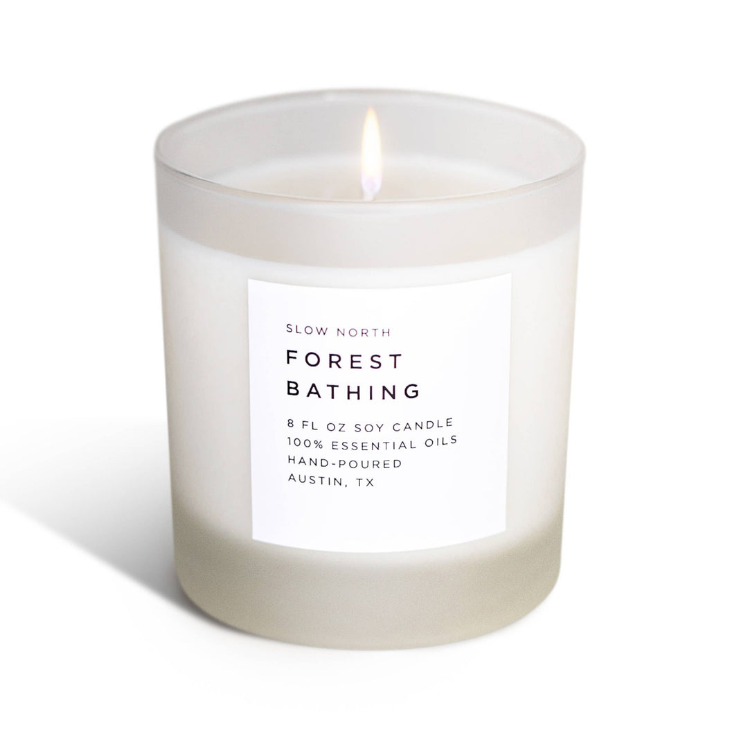 Candle labeled 'Forest Bathing' by Slow North on a white background