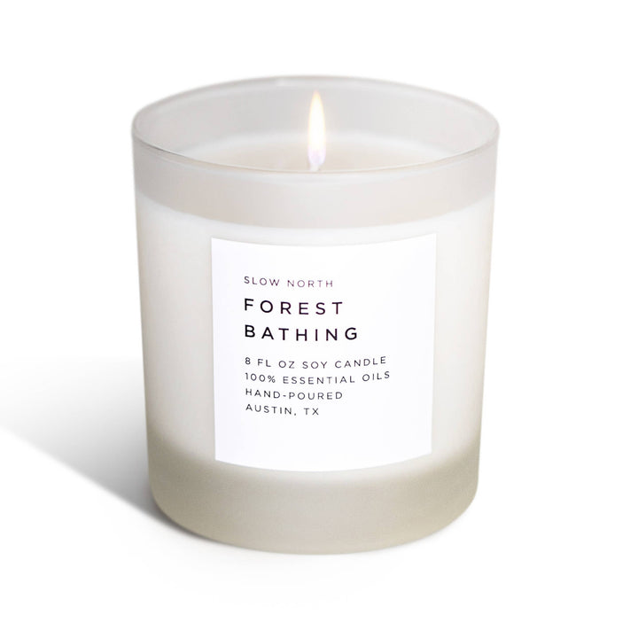 Candle labeled 'Forest Bathing' by Slow North on a white background
