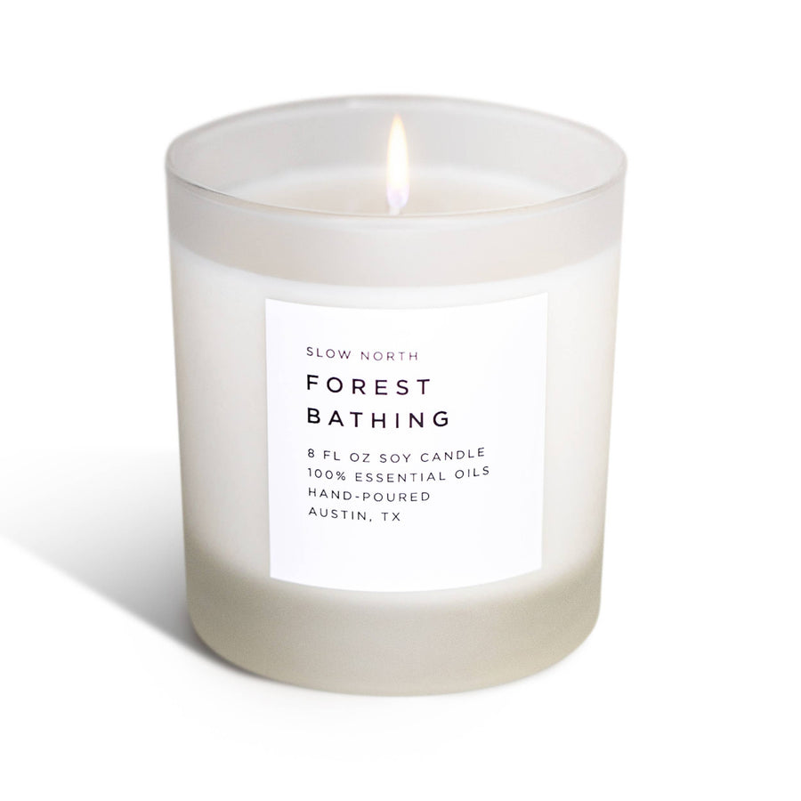 Candle labeled 'Forest Bathing' by Slow North on a white background