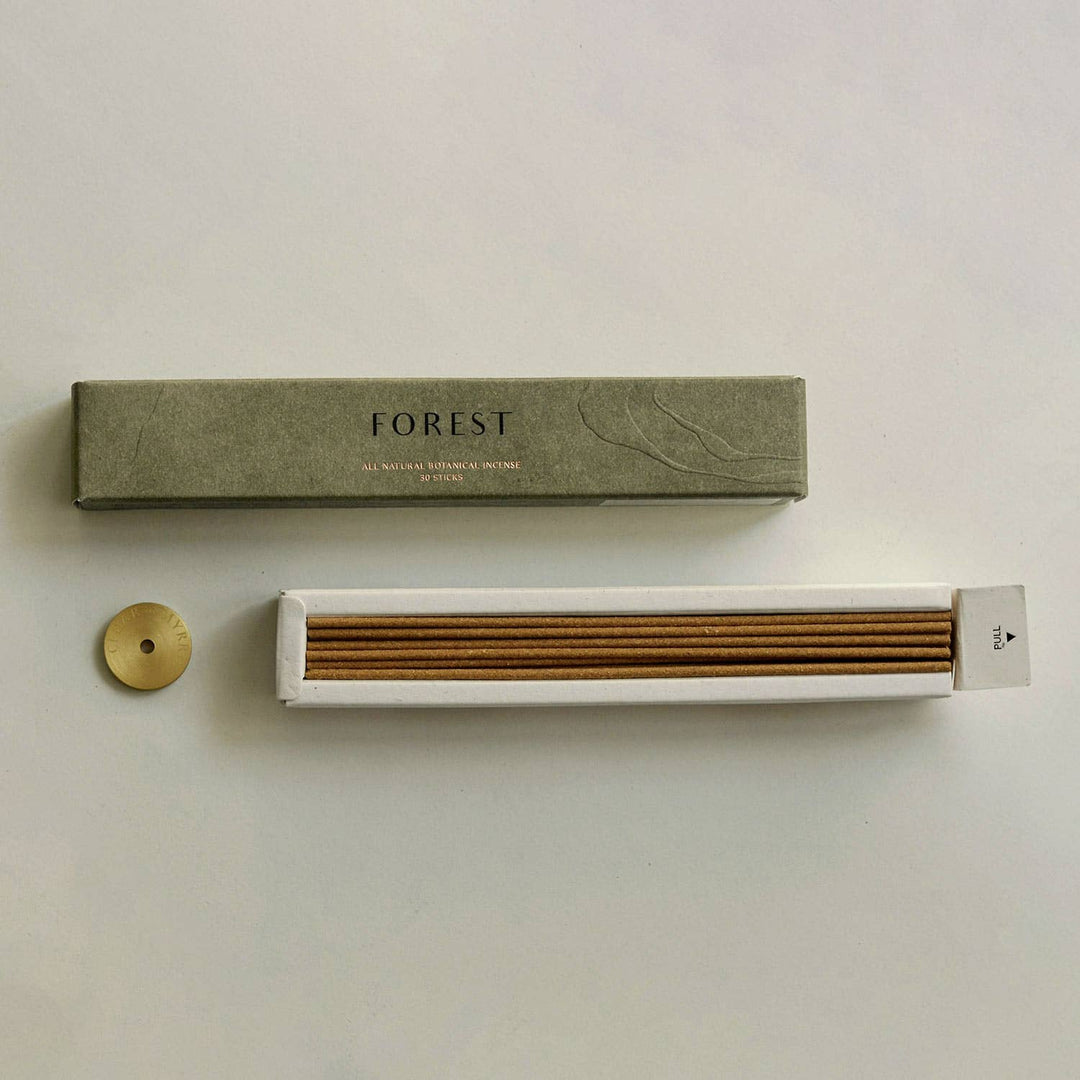 Incense stick set with packaging labeled 'Forest' on a light background