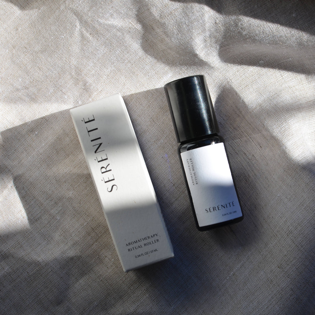 Sérénite aromatherapy roller bottle and packaging on a textured surface