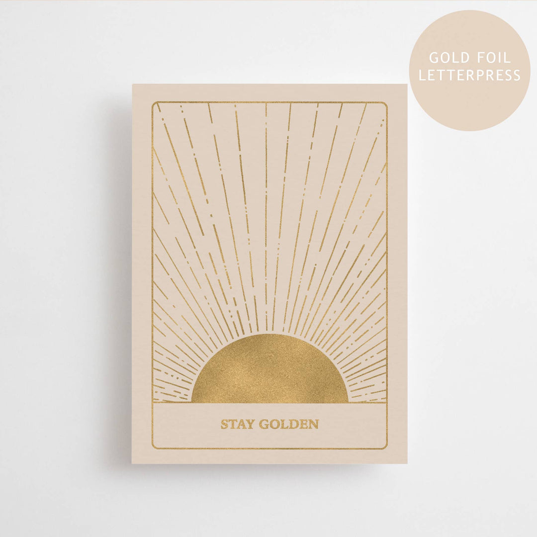 Beige card with gold foil sun design and 'Stay Golden' text on a white background