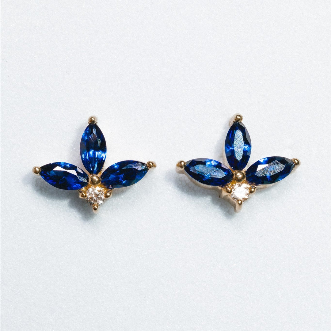 Pair of blue gemstone earrings on a light gray background