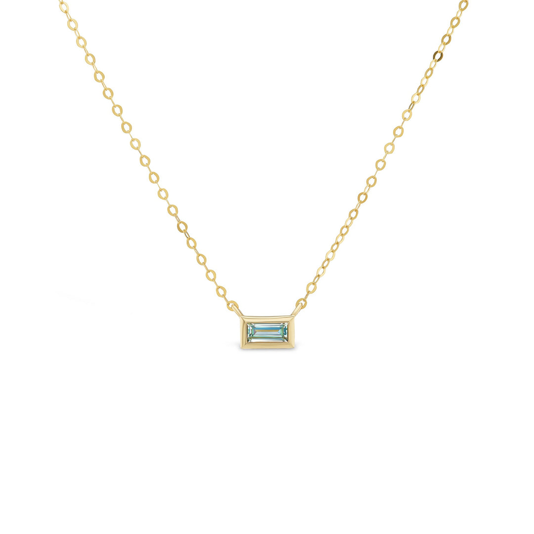 Gold necklace with a rectangular gemstone pendant on a white background