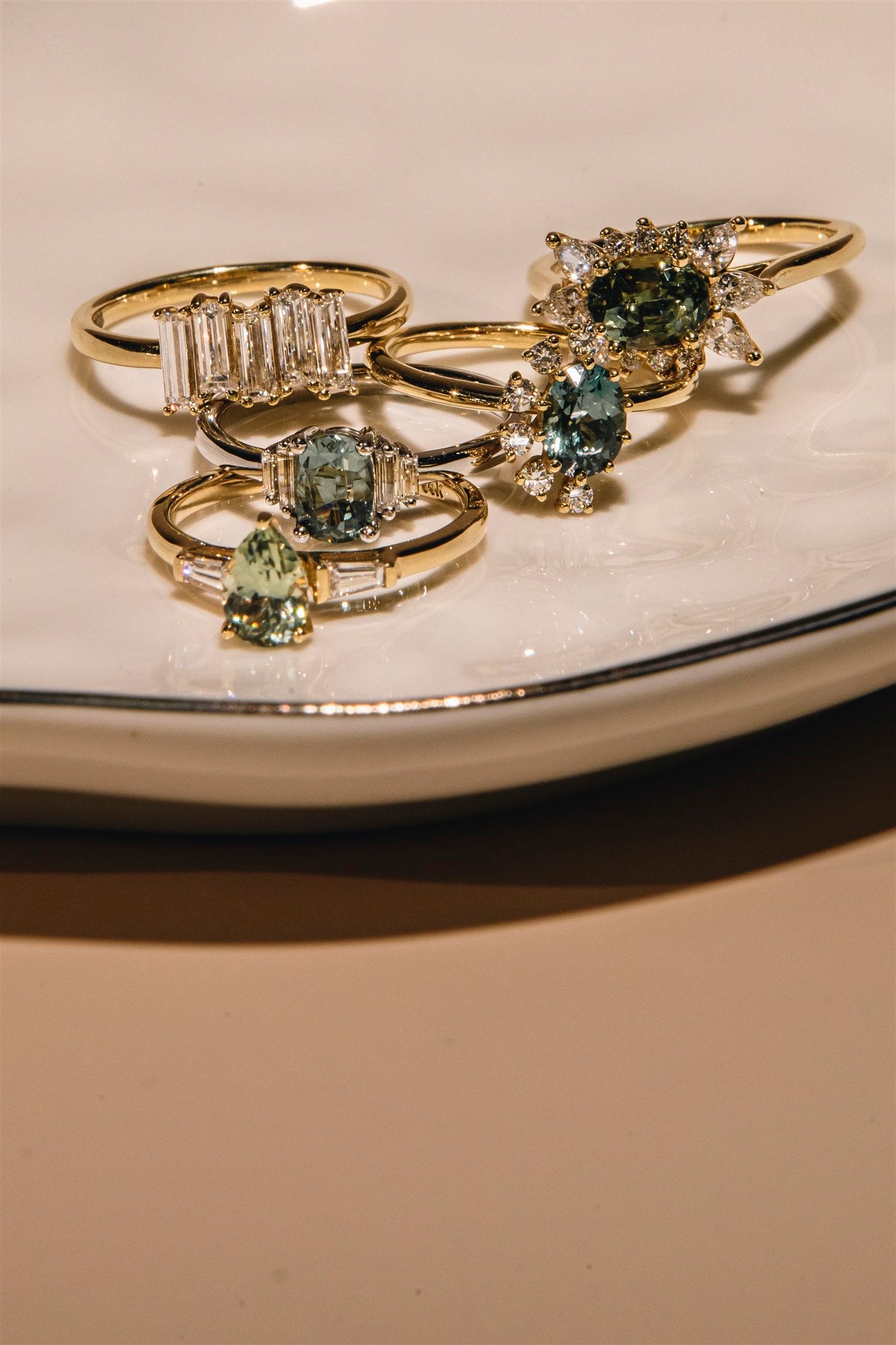 Talismania fine rings in solid 14K gold with Montana sapphitres, arranged together -- Talismania