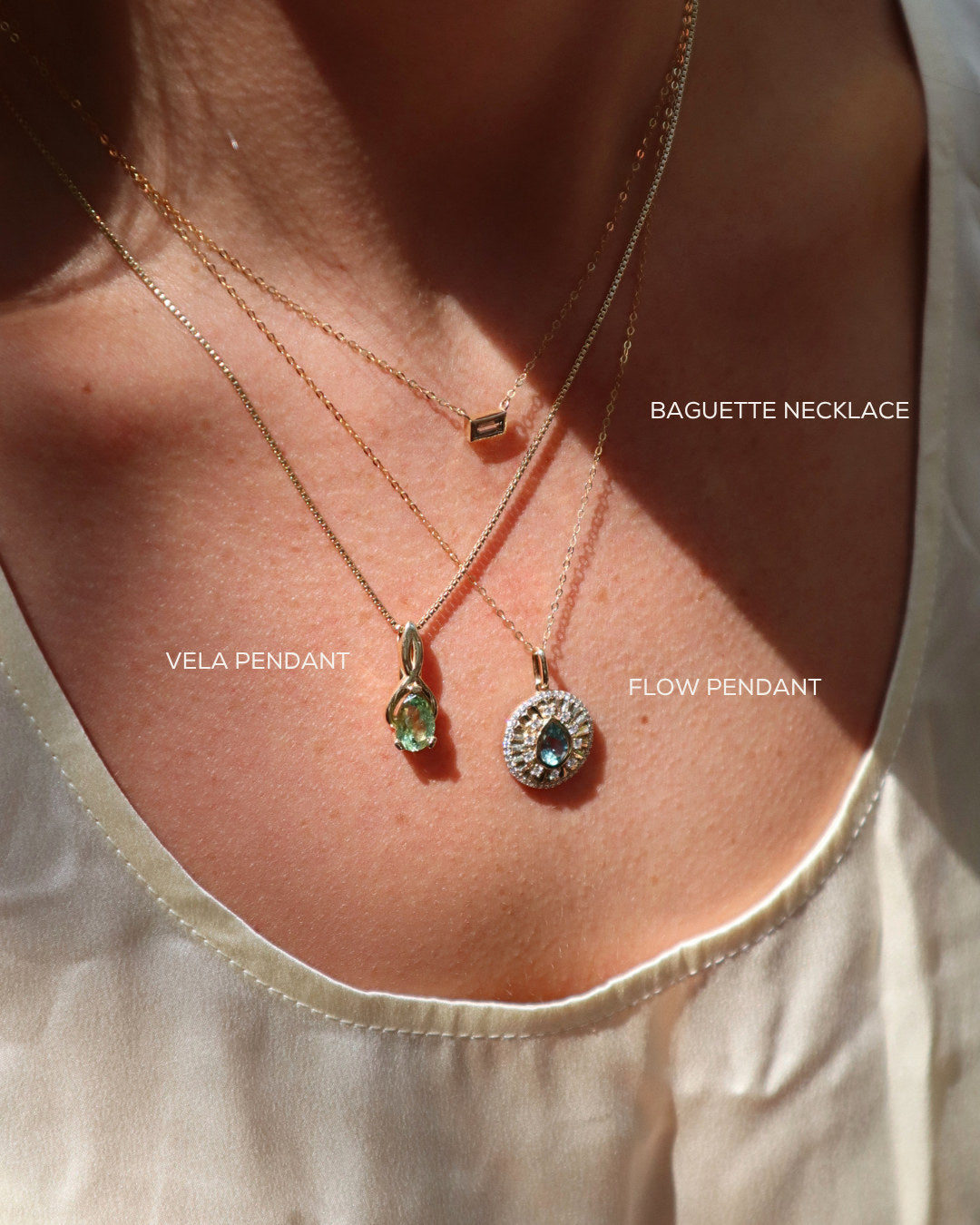 Layered Talismania necklaces in solid 14K gold with Montana sapphires, worn with stacked rings — Talismania