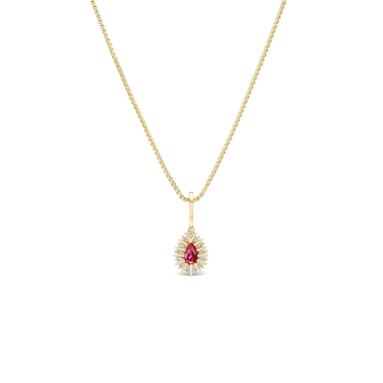 Gold necklace with a red gemstone pendant on a white background